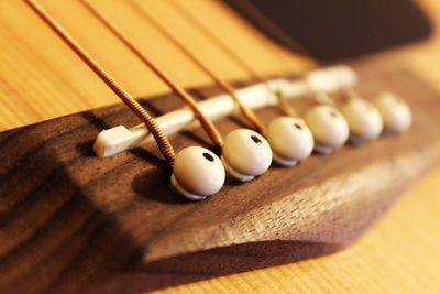 Cropped image of acoustic guitar bridge pins