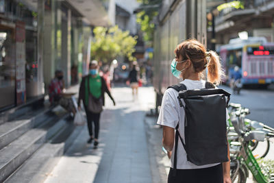 Woman walking on street in city