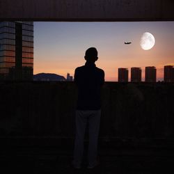 Silhouette man standing against clear sky during sunset