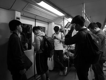 Rear view of people walking in bus