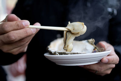 Close-up of person holding ice cream in bowl