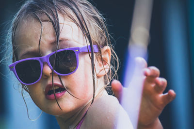 Close-up of portrait of cute girl wearing sunglasses