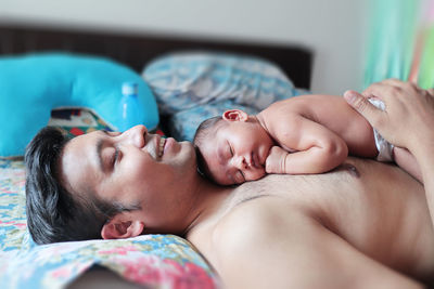 Midsection of mother and baby sleeping