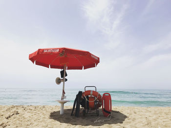 Lifeguard hut on beach against sky