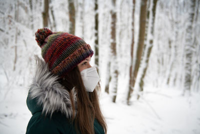 Rear view of woman standing in forest