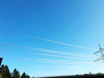 Low angle view of power lines against blue sky