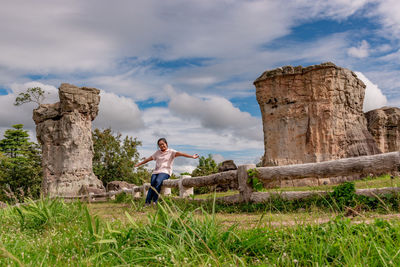 Full length of man climbing on land against sky