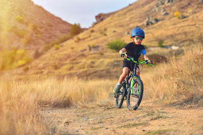 Man riding bicycle on field