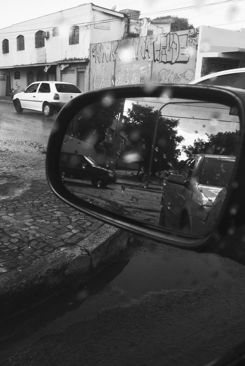 CLOSE-UP OF CAR ON SIDE-VIEW MIRROR