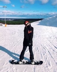 Full length of man standing on snow against sky