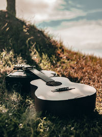 Close-up of guitar on field