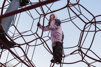 Girl on climbing frame