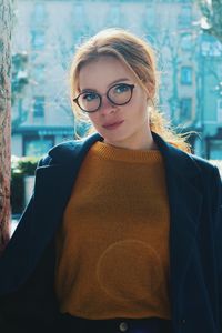 Portrait of woman standing in city