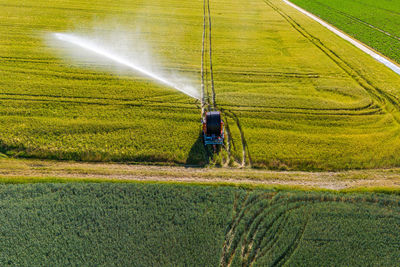 Water jet through sprinklers on an agricultural field, aerial view, germany