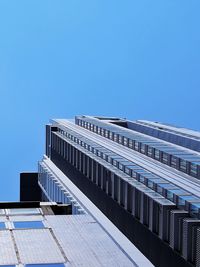 Low angle view of modern building against clear blue sky