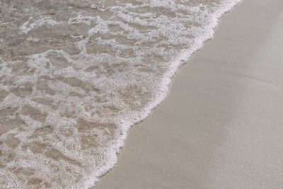 High angle view of waves rushing towards shore