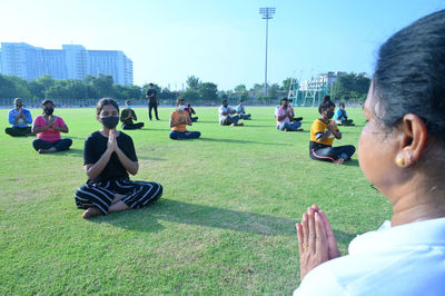 Rear view of people sitting at park