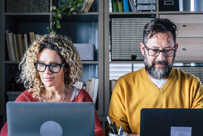 Business people looking at computer in office