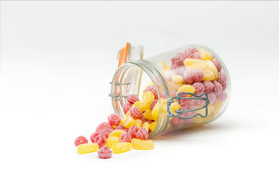 Close-up of multi colored candies against white background