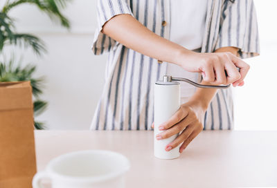 Midsection of woman using mobile phone