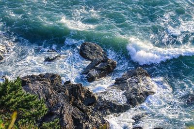 High angle view of rocks in sea