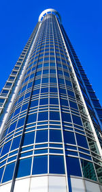 Low angle view of modern building against clear blue sky