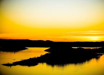 Scenic view of lake at sunset