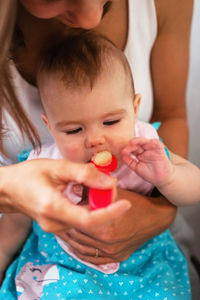 Mother feeding little daughter vegetable puree from a spoon. healthy eating nutrition for children.