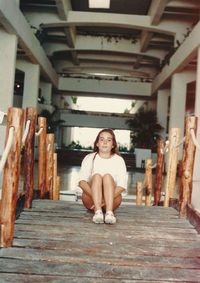 Portrait of woman sitting in corridor