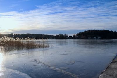 Scenic view of frozen lake against sky during winter