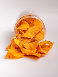 High angle view of orange leaf on white background