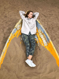 High angle view of woman lying on carpet