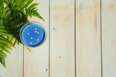 High angle view of blue paint on table