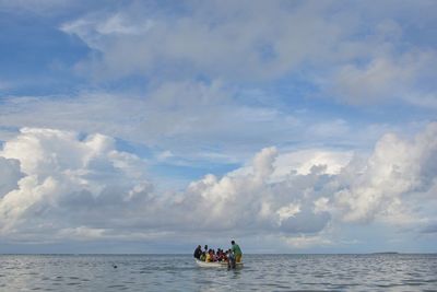 People in boat on sea