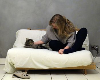 Woman with cat on sofa