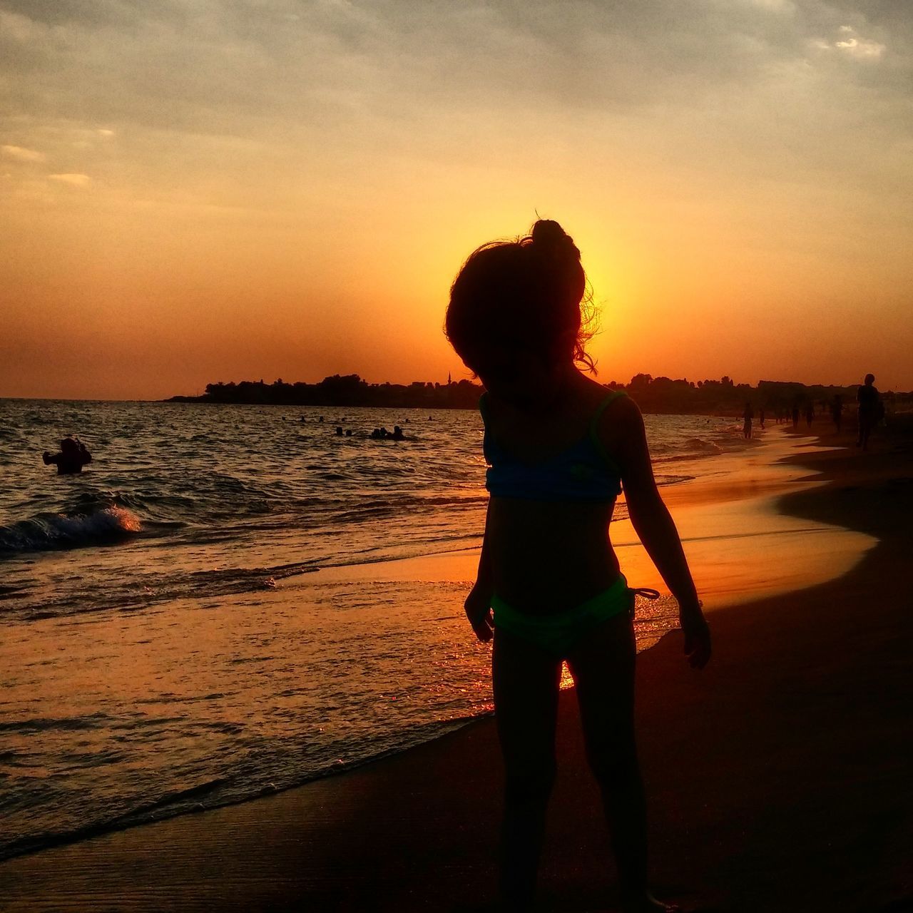 sunset, beach, sea, water, orange color, lifestyles, sky, leisure activity, shore, standing, full length, beauty in nature, scenics, tranquil scene, tranquility, horizon over water, silhouette, sand