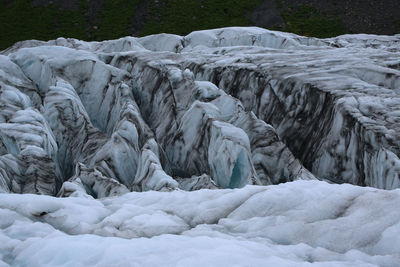 Frozen river flowing in winter