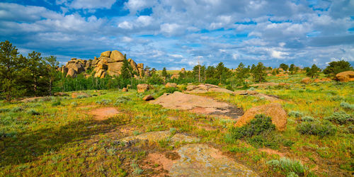 Rock formations on landscape against sky