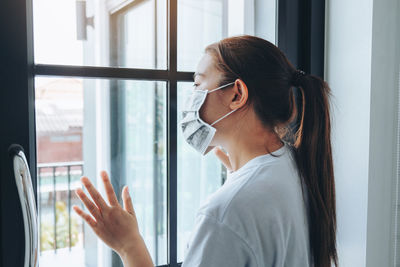 Portrait of woman in glass window