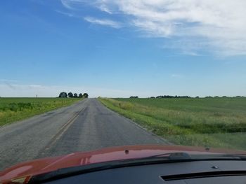 Road passing through landscape against sky