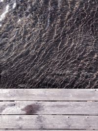 Full frame shot of wet boardwalk