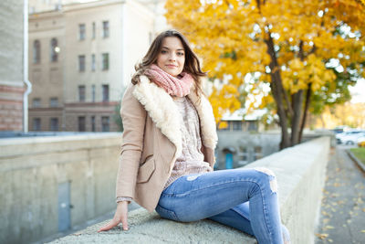 Portrait of woman sitting in snow