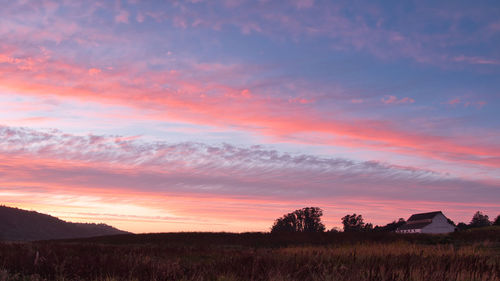 Scenic view of field against sky during sunset