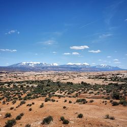 Scenic view of landscape against blue sky