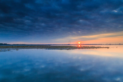 Scenic view of sea against sky at sunset