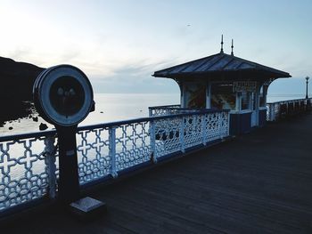 Built structure by sea against sky