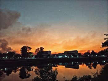 Scenic view of lake against sky at sunset