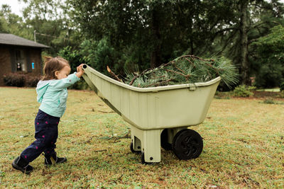 Rear view of boy playing in yard