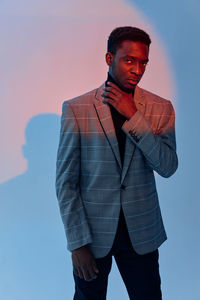 Portrait of businessman standing against white background