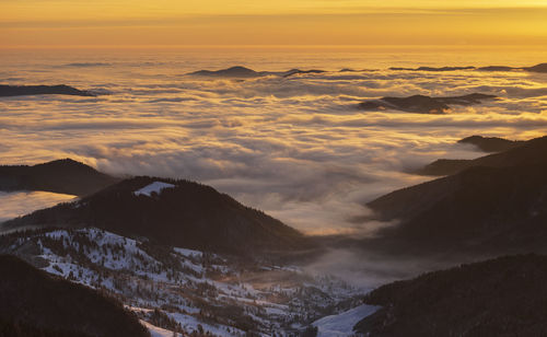 The beauty of winter on the snowy mountains at sunrise with alpine sea. ceahlau mountains, romania